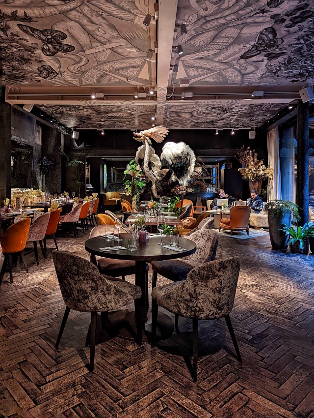 A decadent restaurant interior featuring a taxidermy ostrich